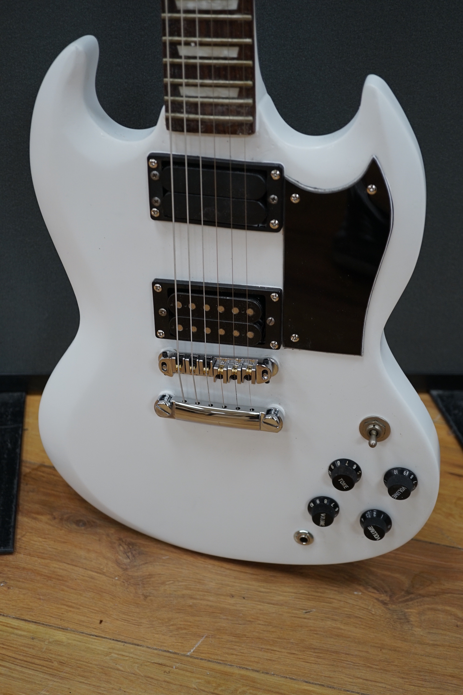 A white painted electric six string guitar